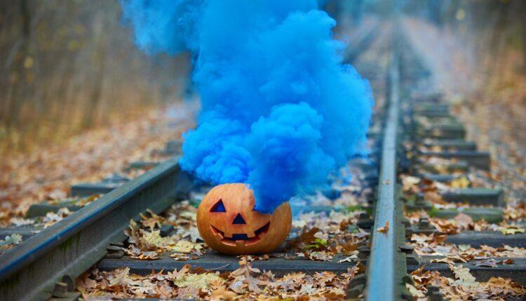 Citrouille sur un chemin de fer avec un fumigène bleu