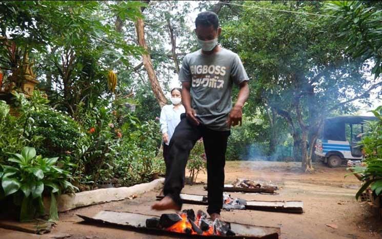 Rapper Kea Sokun, 22, takes part in a cleansing ceremony outside his house in Siem Reap following his release from prison on September 3, 2021. (Jack Brook/VOD)