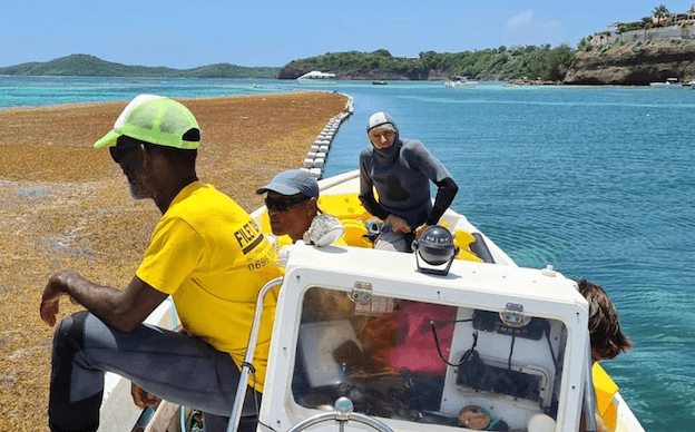 Luc Hardy en combinaison de plongée dans un bateau