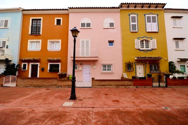 une ruelle et des façades oranges bleues roses et jaunes