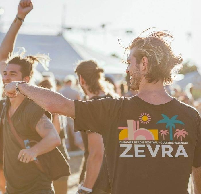 des festivaliers de dos avec des t shirts noirs zevra festival