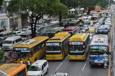 Des bus circulent et s'arrêtent sur quatre files, bloquant la circulation