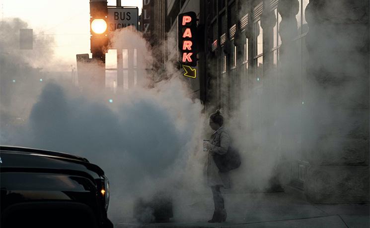 Une voiture à gauche et une personne à droite dans la pollution