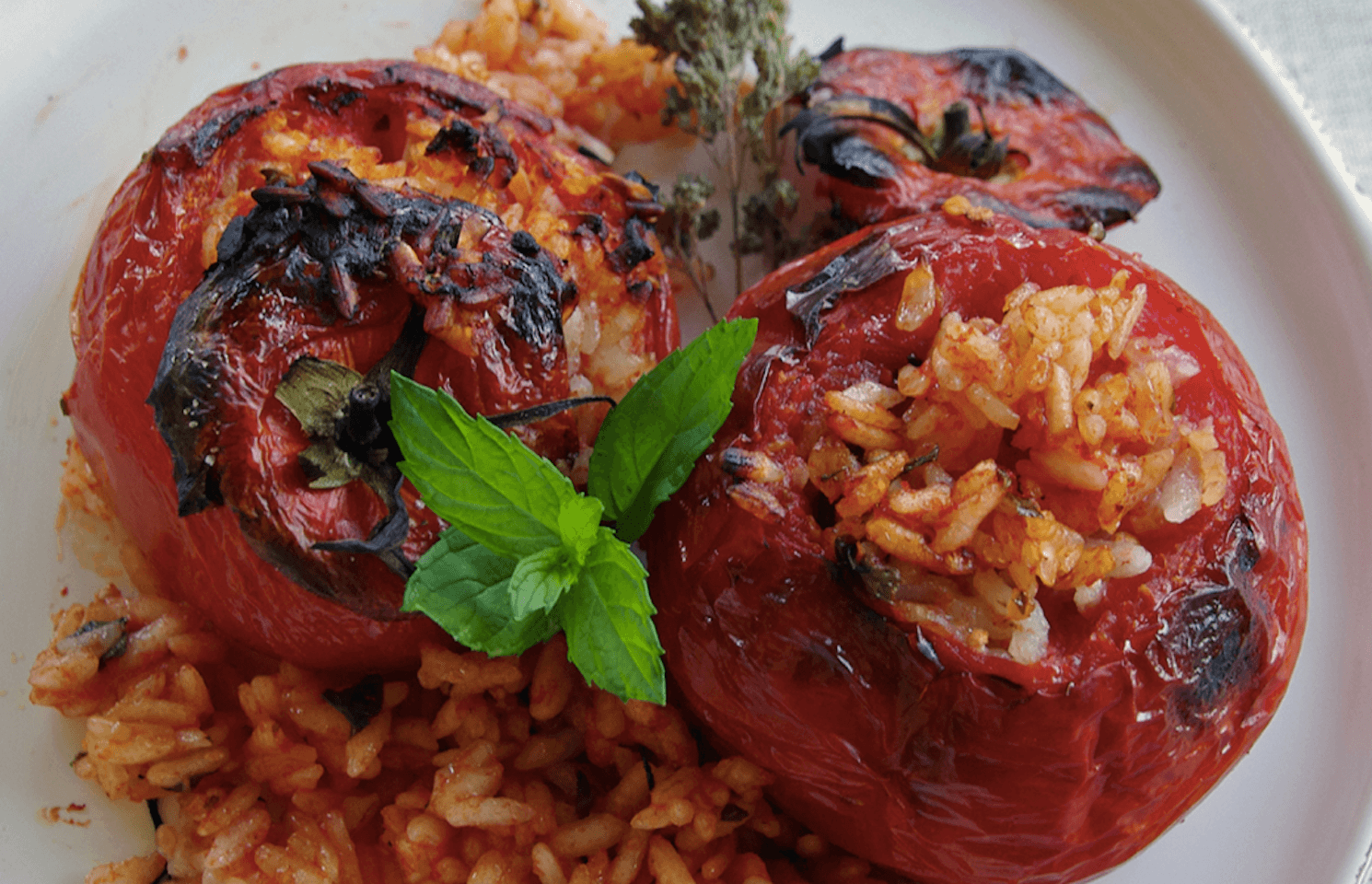 Tomates au riz cuit au four avec une feuille de basilic