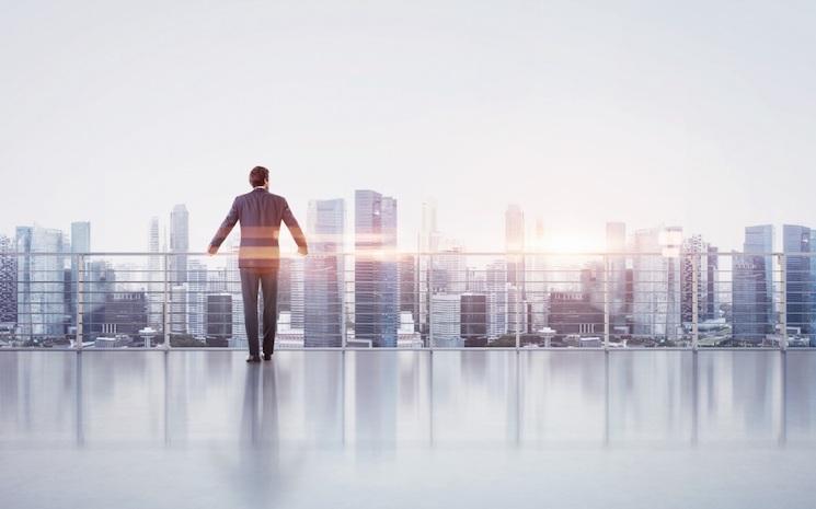 homme à un balcon qui regarde la ville