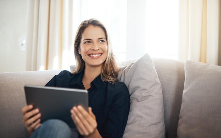 Femme sur un canapé gérant son épargne