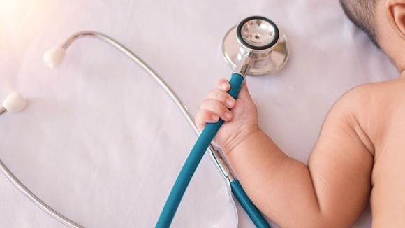 un bebe qui tient un stethoscope dans sa main