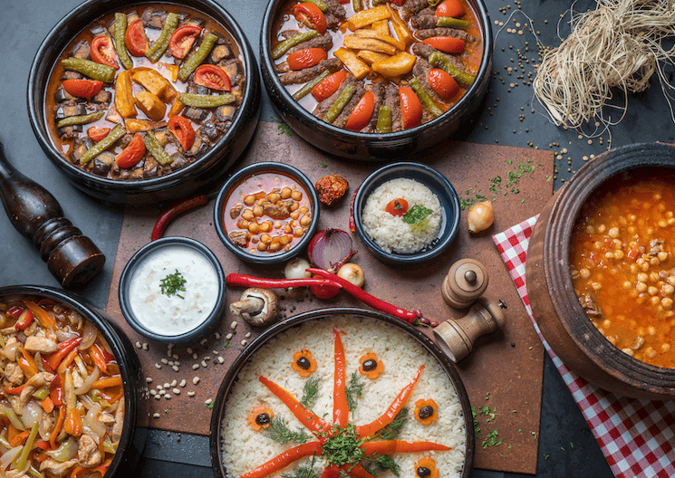 Assortiment de plats turcs traditionnels, incluant du riz, des légumes mijotés, et des spécialités locales, servi dans un style élégant et chaleureux.