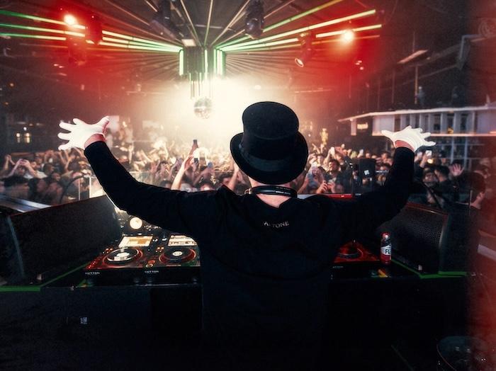 un dj de dos avec un chapeau et des gants blancs au Sutton Barcelona