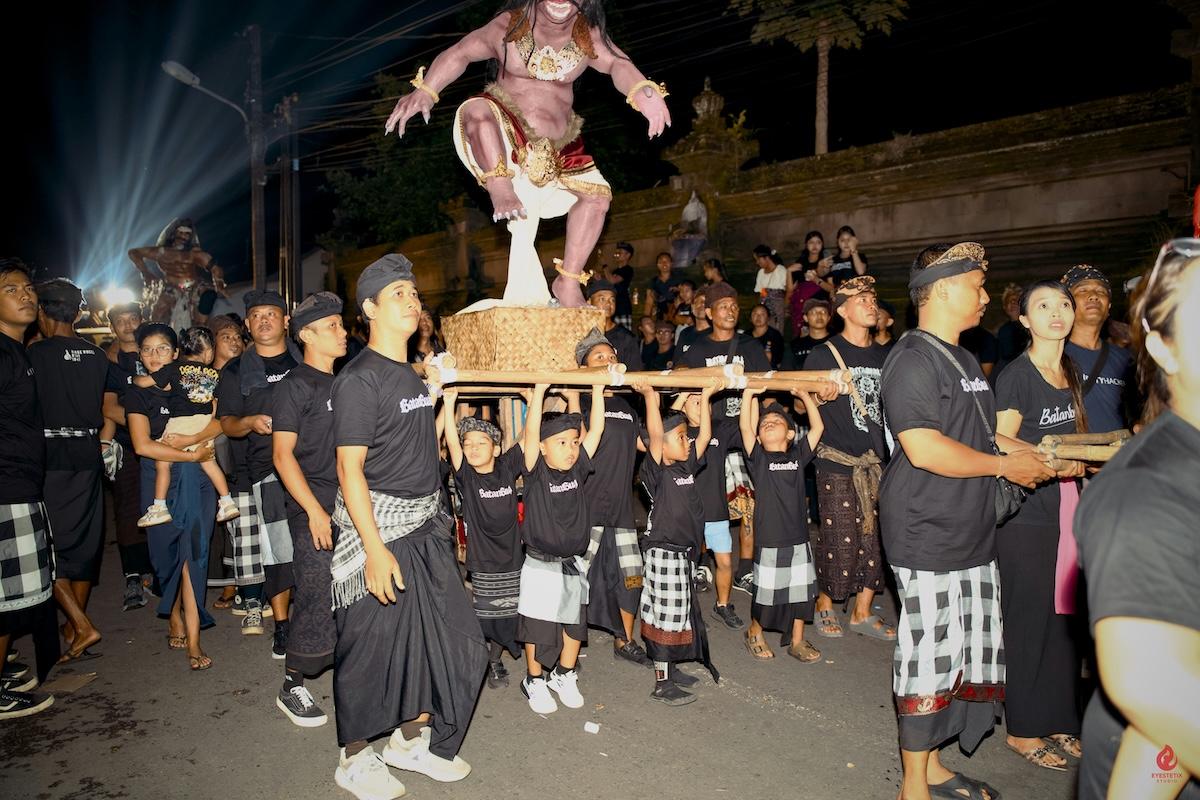 des hommes à bali qui portent un ogoh ogoh durant nyepi