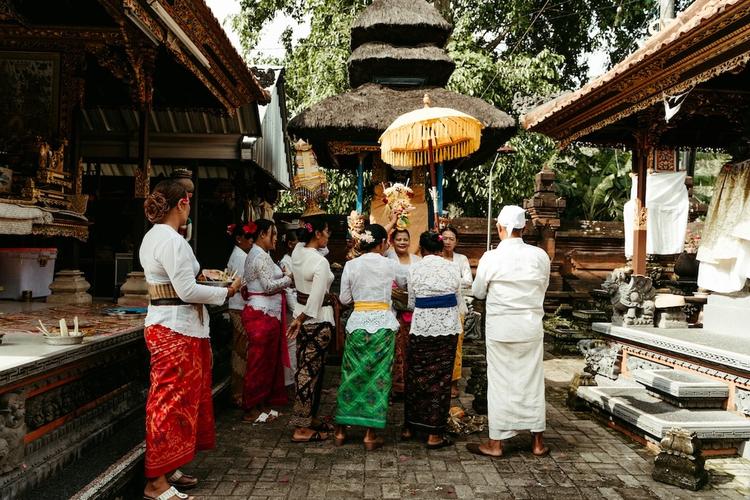 des balinais devant un temple en tenue traditionnelle