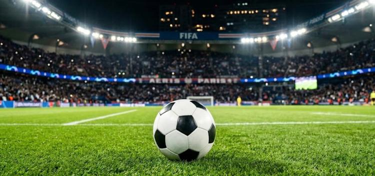 Un ballon de football sur un stade éclairé représentant les matchs FIFA 2026