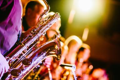 un groupe de jazz avec un saxophone au premier plan