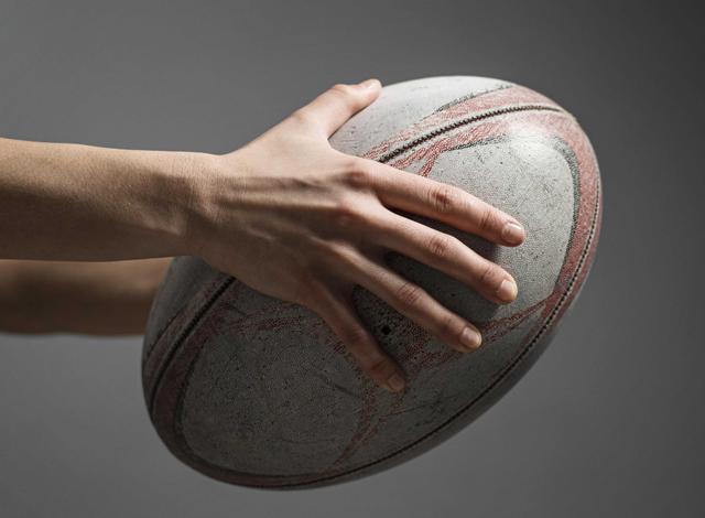 side-view-female-rugby-player-s-hand-holding-ball
