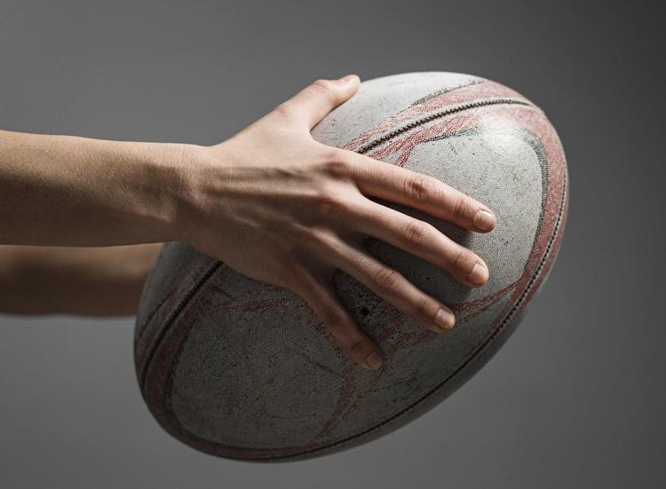 side-view-female-rugby-player-s-hand-holding-ball