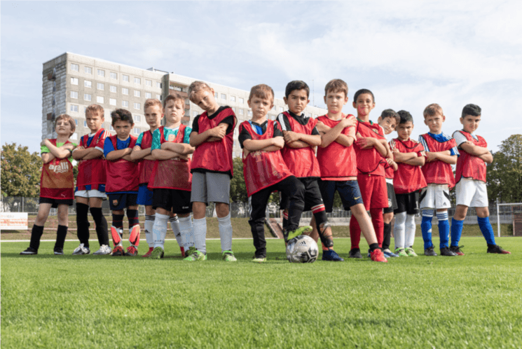 Une équipe de foot composée d'enfants posant comme des professionels