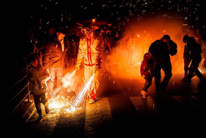 des personnes près de flammes lors de la Correfoc à Valencia