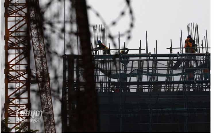 Laborers work at a construction site in Phnom Penh CamboJA Pring Samrang.