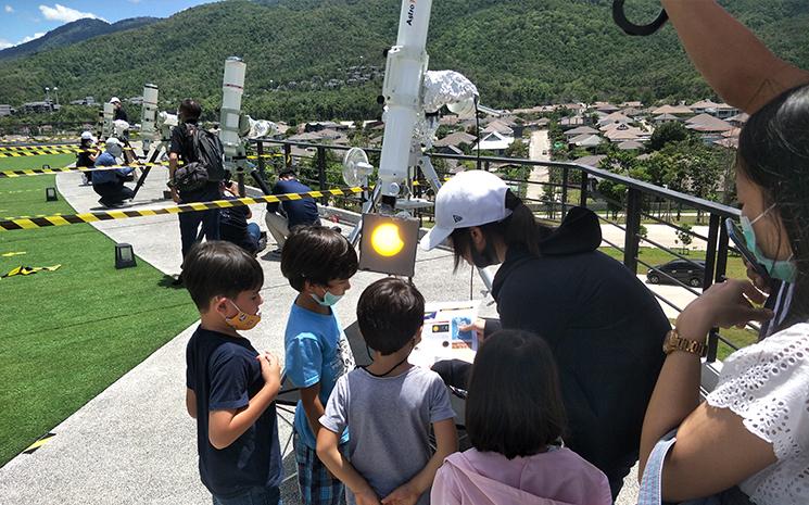 Des enfants observent une eclipse solaire a l'observatoire Narit de Chiang Mai
