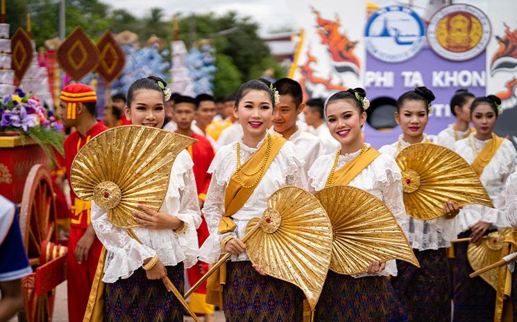 Defile de jeunes femmes en tenue traditionnelle lors du festival du Phi Ta Khon dans la province de Loei en Thailande