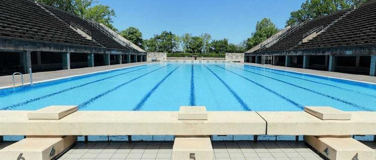 Un long bassin de piscine entouré de gradins