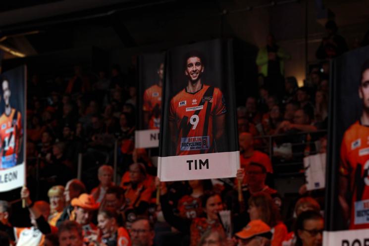 Fan portant un portrait de Tim Carle dans le public lors d'un match de volley