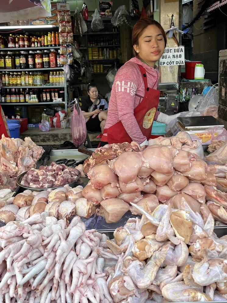 Une bouchère et son étal de poulet.