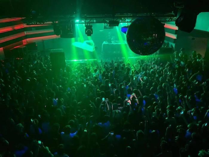 un concert avec des lumières vertes fluo dans le festival Flow à Valencia