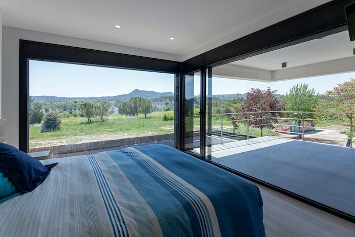 une chambre avec grandes baies vitrées Hormipresa