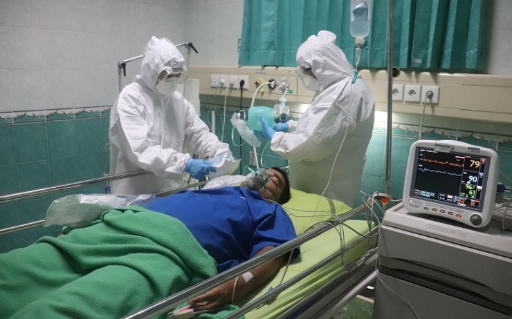 Des soignants surveillent un malade du covid a l'hopital