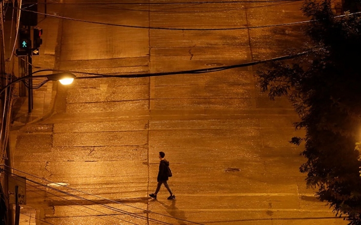 Un homme marche seul dans la rue sous couvre-feu