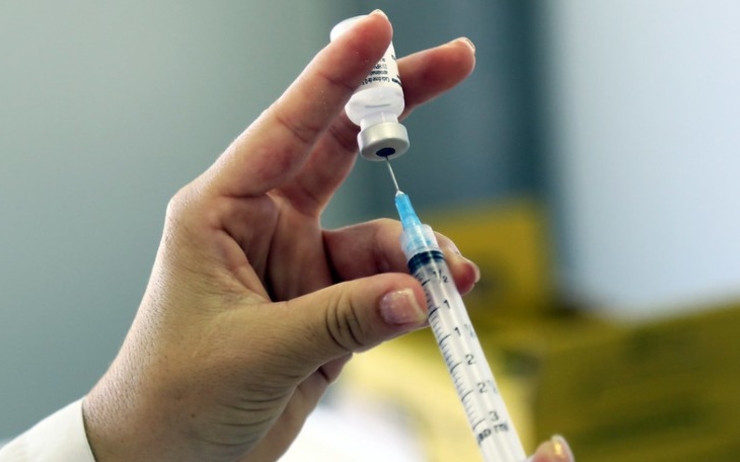 Un médecin en train de remplir une seringue pour une vaccination covid-19