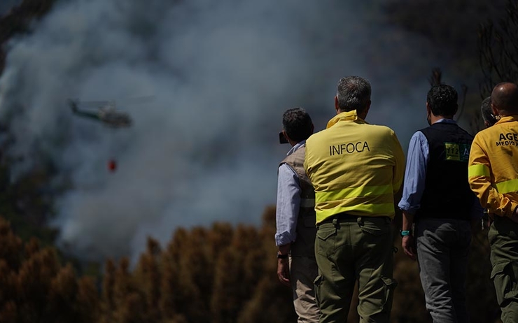 El presidente andaluz y miembros del Infoca contemplan las tareas de extinción del fuego.