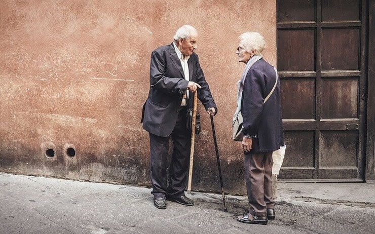 des personnes âgées discutent dans la rue