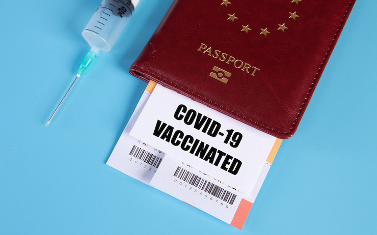 Passeport, certificat de vaccination contre le Covid-19 et seringue