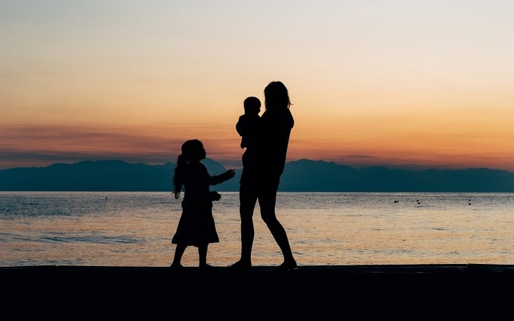 mère et deux enfants au coucher de soleil