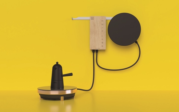 Objects design posés sur une table contre un mur jaune 