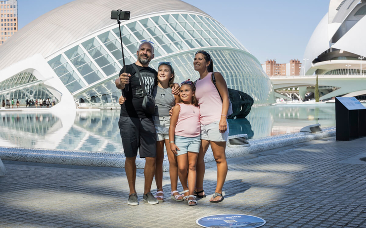 une famille en train de prendre un selfie devant l hemisferic a valencia