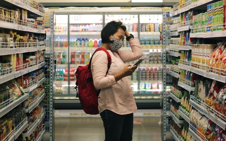 un femme avec un masque dans un rayon de supermarché à Valencia